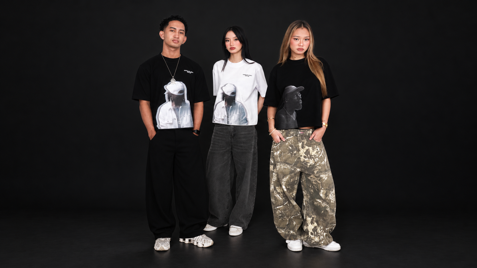 PD Shoot 02 gallery Image 12: three models facing forward, shown full body against a wide black studio backdrop